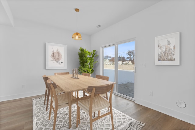 dining space featuring wood-type flooring