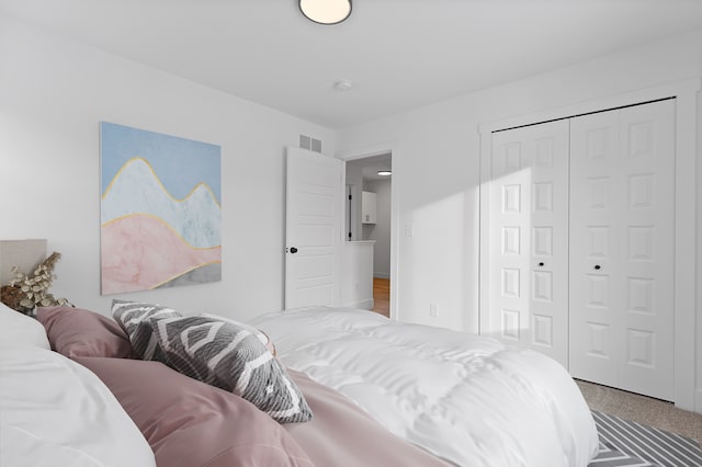 carpeted bedroom featuring a closet