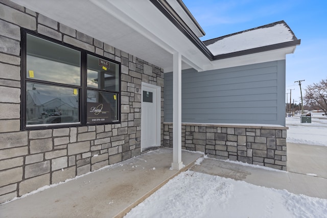 view of snow covered property entrance