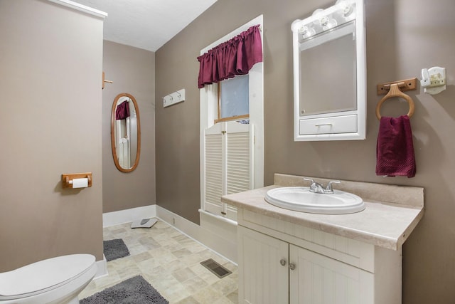 bathroom with vanity and toilet