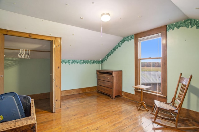 additional living space with lofted ceiling and light hardwood / wood-style floors