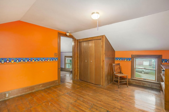 bonus room with lofted ceiling and hardwood / wood-style floors