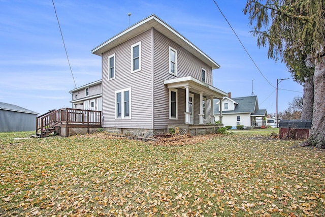 exterior space featuring a wooden deck and a lawn