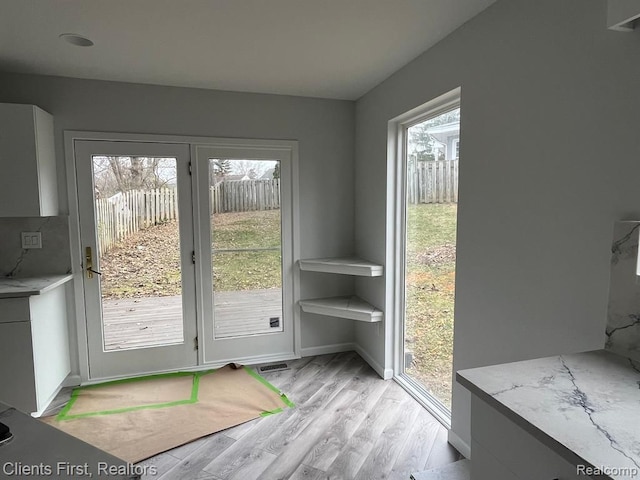 doorway to outside with light hardwood / wood-style flooring