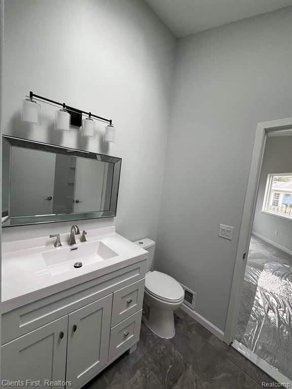 bathroom with vanity and toilet