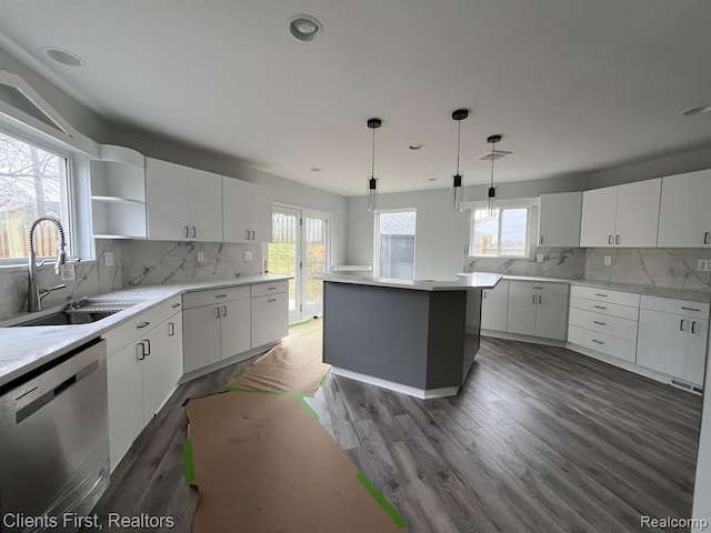 kitchen featuring white cabinetry, sink, dishwasher, and a kitchen island