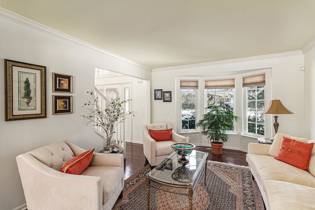 living area with baseboards, ornamental molding, and dark wood-style flooring