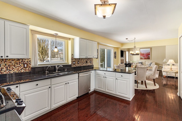 kitchen featuring white cabinetry, hanging light fixtures, a peninsula, and stainless steel dishwasher