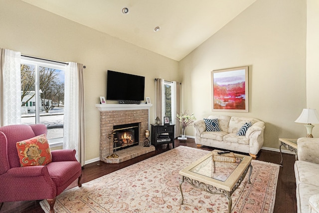 living area with high vaulted ceiling, a fireplace, dark wood finished floors, and baseboards