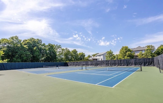 view of tennis court featuring fence