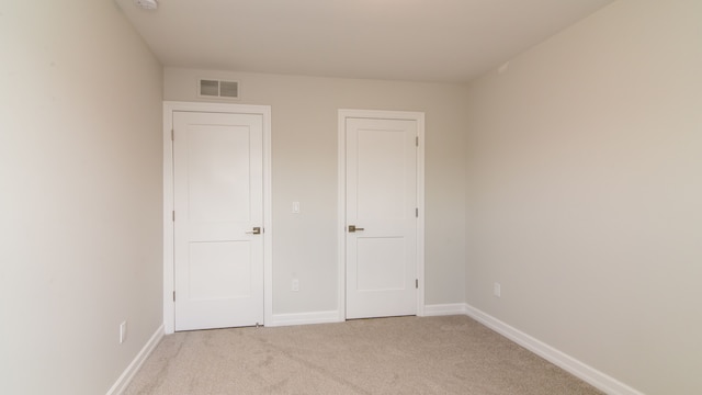 unfurnished bedroom featuring light colored carpet