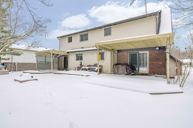 view of snow covered rear of property