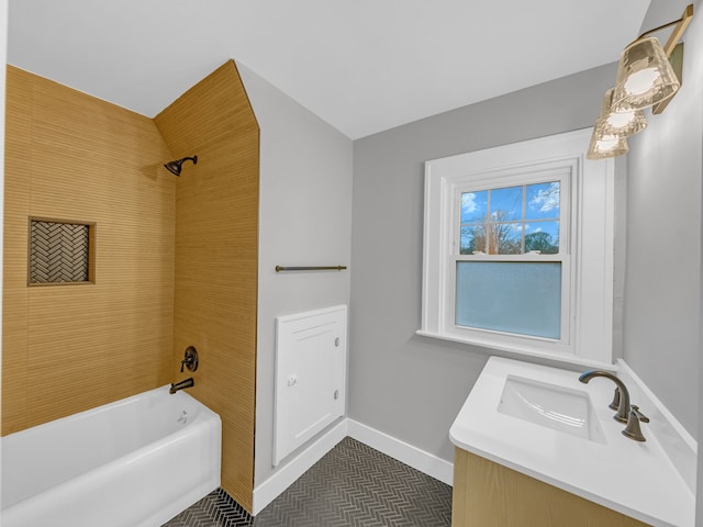 bathroom with tiled shower / bath combo and vanity