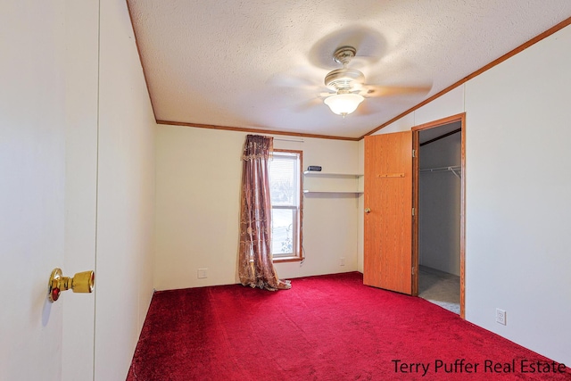 unfurnished bedroom with ceiling fan, ornamental molding, a textured ceiling, and carpet flooring