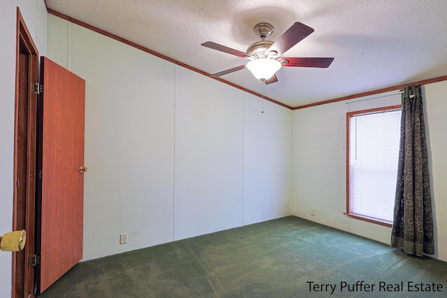 unfurnished room featuring crown molding, ceiling fan, a textured ceiling, and dark carpet