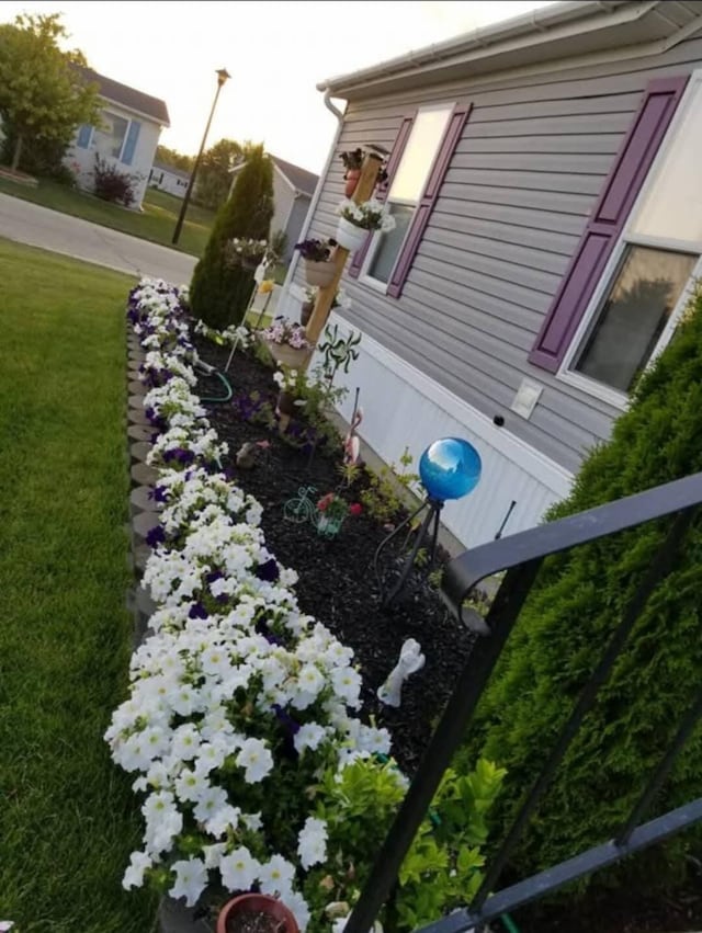 view of side of property with a yard