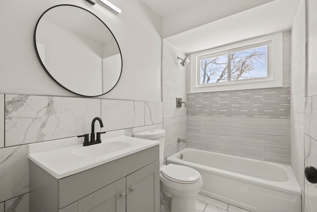 full bathroom with tiled shower / bath combo, vanity, tile walls, and toilet