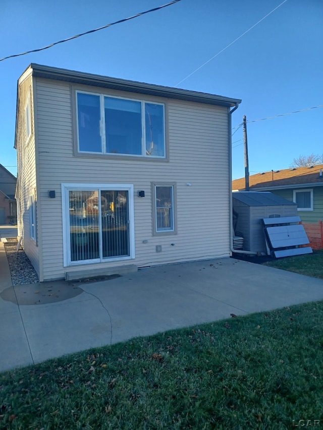 rear view of property featuring a yard and a patio