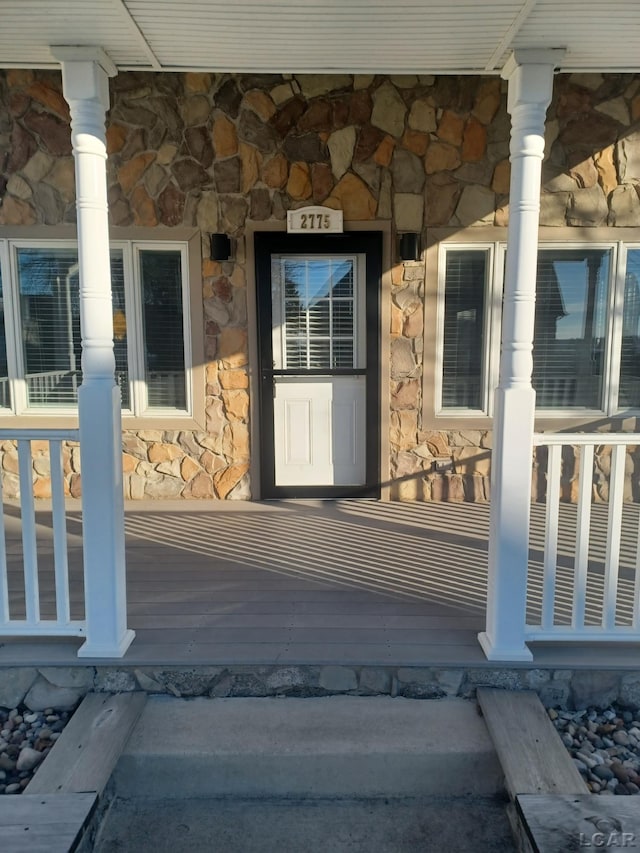 view of exterior entry featuring a porch