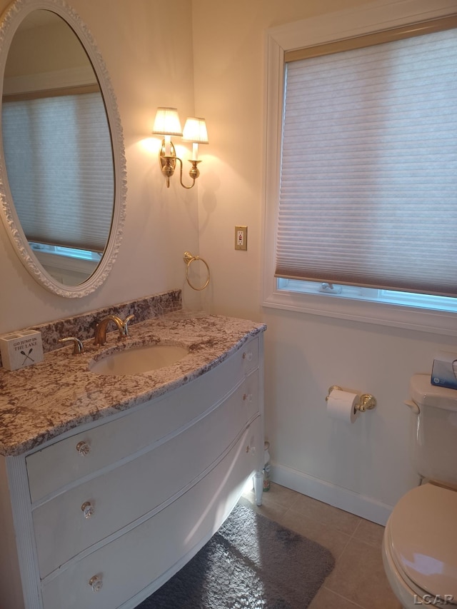 bathroom featuring vanity, tile patterned floors, and toilet