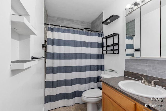 bathroom featuring backsplash, toilet, vanity, and a shower with curtain