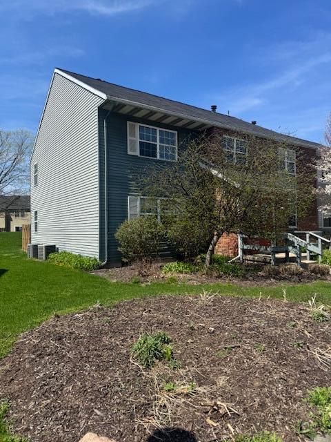 back of property featuring a lawn