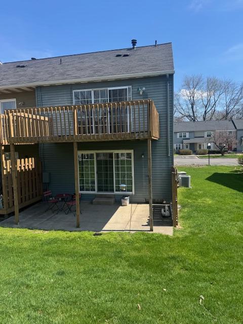 rear view of house with a yard, a patio, central AC unit, and a deck