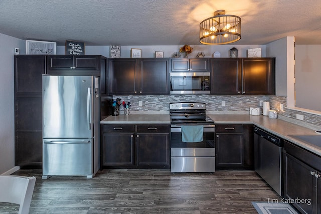 kitchen featuring stainless steel appliances, dark hardwood / wood-style flooring, and decorative backsplash