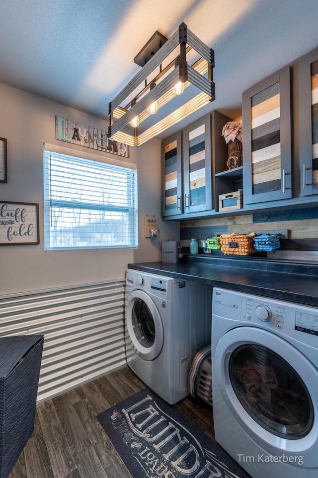 laundry room with cabinets, dark hardwood / wood-style floors, and washer and dryer