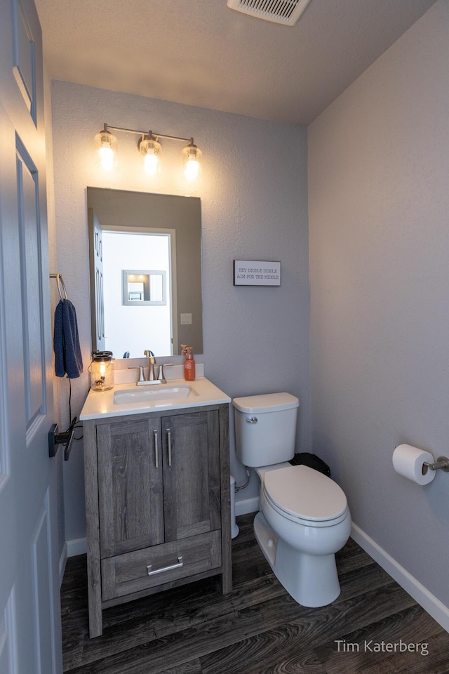 bathroom with vanity, hardwood / wood-style floors, and toilet