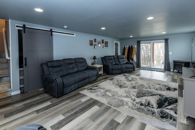 living room featuring hardwood / wood-style flooring and a barn door