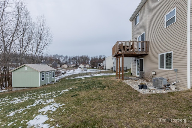 view of yard featuring an outbuilding, a deck, and central air condition unit