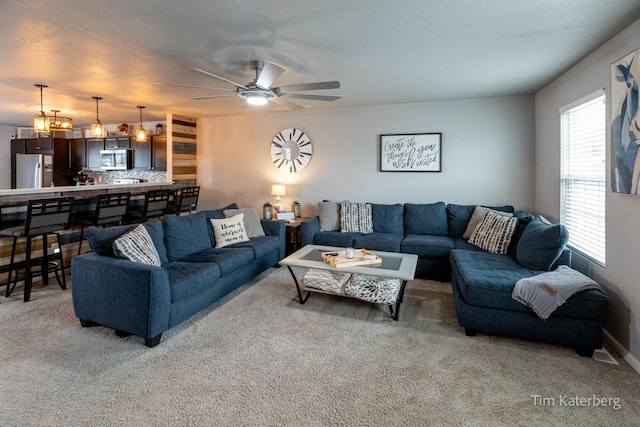 living room featuring ceiling fan and carpet flooring