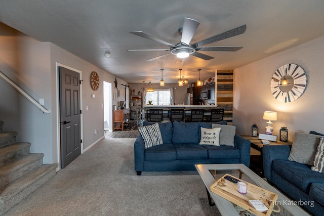 living room with carpet floors and ceiling fan