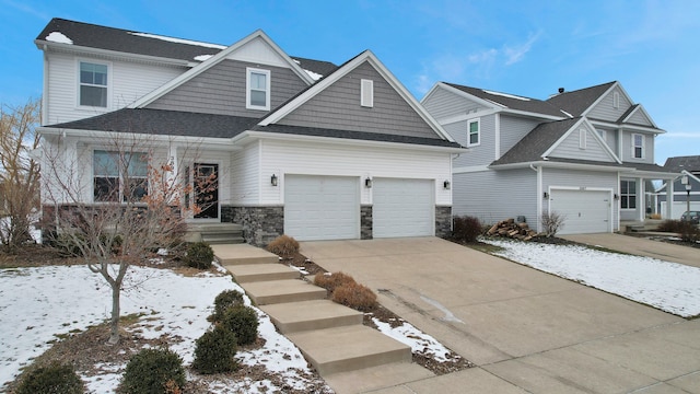 view of front of home featuring a garage, stone siding, and driveway