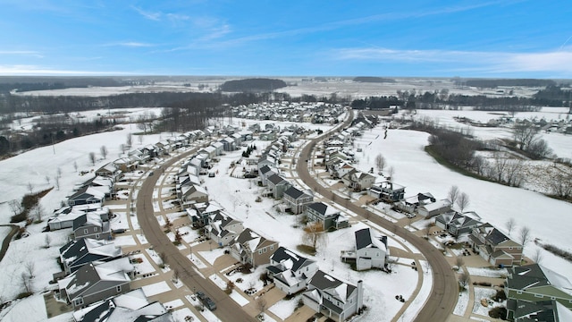 snowy aerial view with a residential view