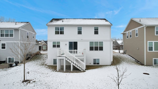 view of snow covered rear of property