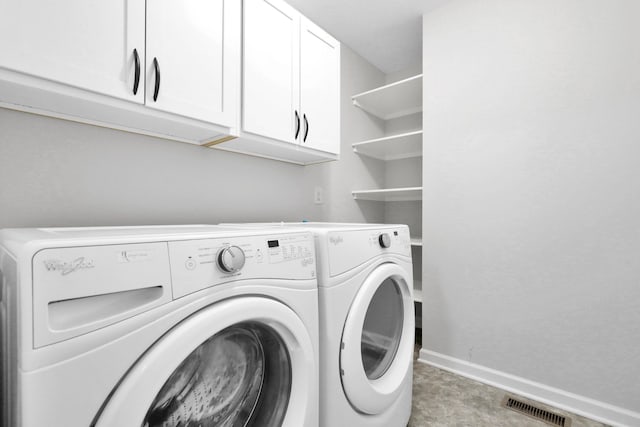 laundry room featuring cabinet space, baseboards, visible vents, and separate washer and dryer