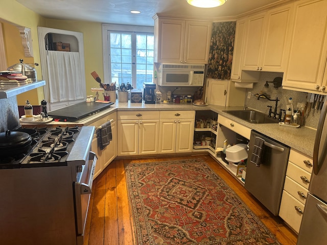 kitchen with dark hardwood / wood-style flooring, sink, white cabinets, and appliances with stainless steel finishes