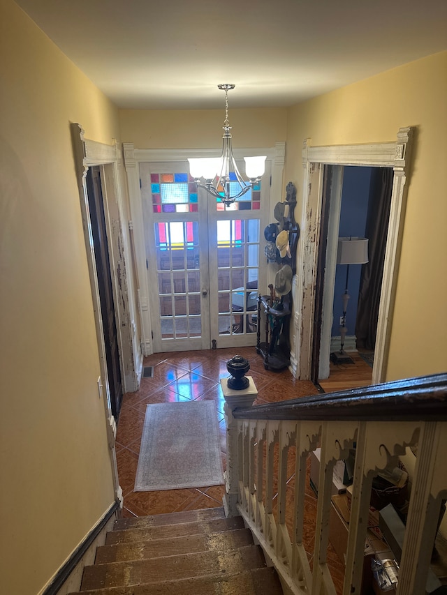 interior space featuring french doors and a chandelier