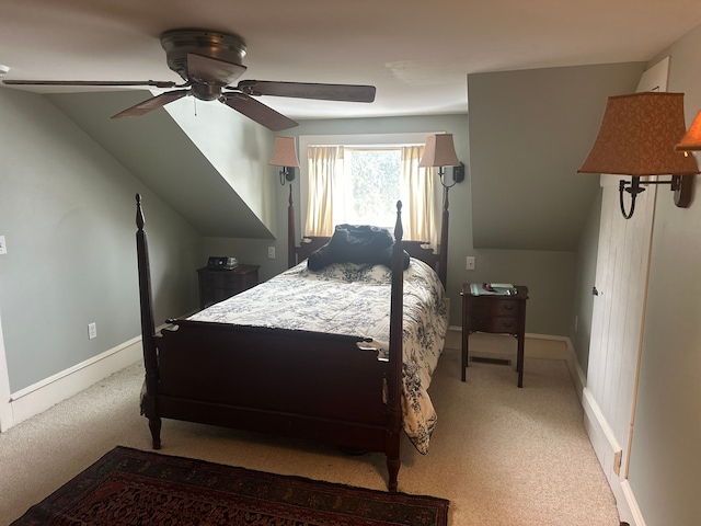 carpeted bedroom featuring lofted ceiling and ceiling fan