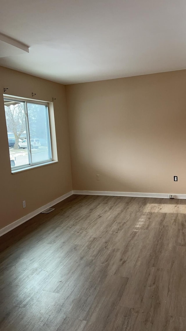 unfurnished room featuring wood-type flooring