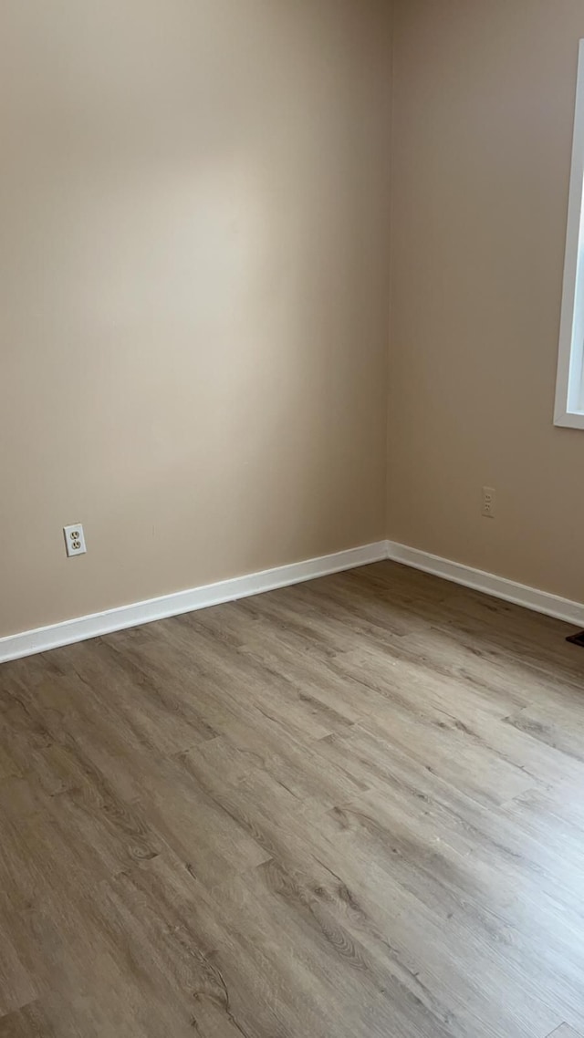 unfurnished room with light hardwood / wood-style flooring