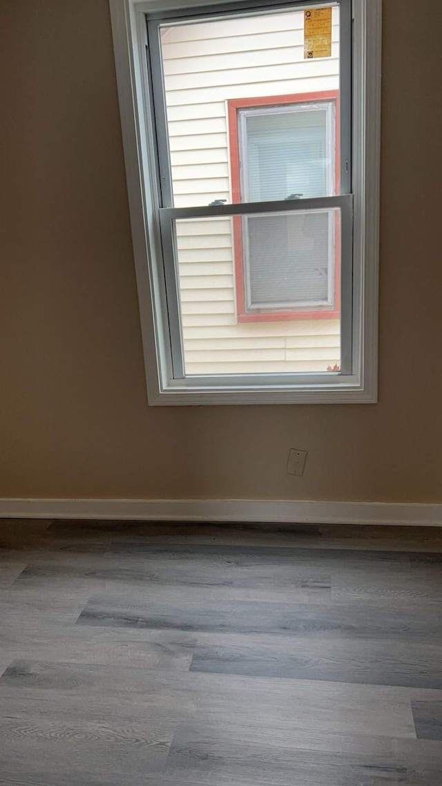 unfurnished room with wood-type flooring