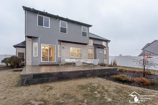 back of property with an outdoor hangout area, a lawn, and a deck