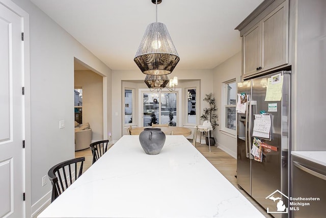 dining area with a chandelier and light wood-type flooring