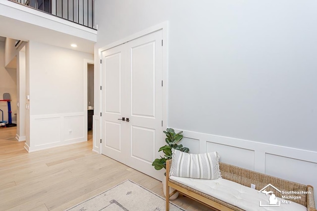 hallway with hardwood / wood-style flooring