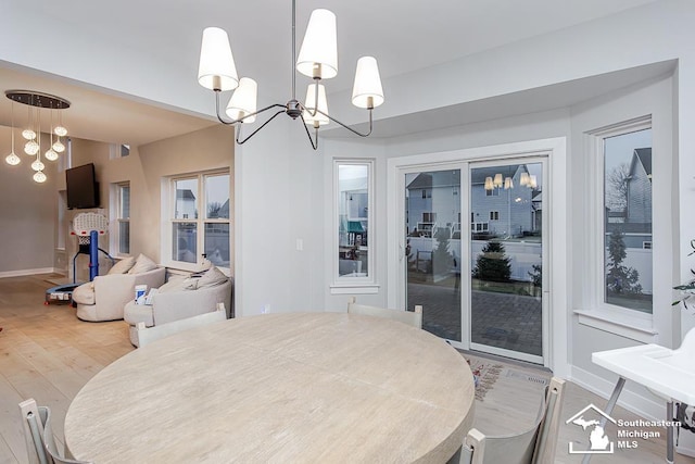 dining area featuring an inviting chandelier and hardwood / wood-style flooring