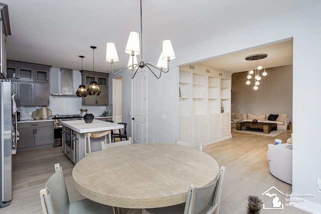 dining room with a chandelier and light hardwood / wood-style flooring