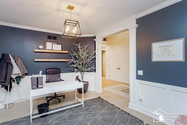 office area featuring crown molding, wood-type flooring, decorative columns, and a chandelier